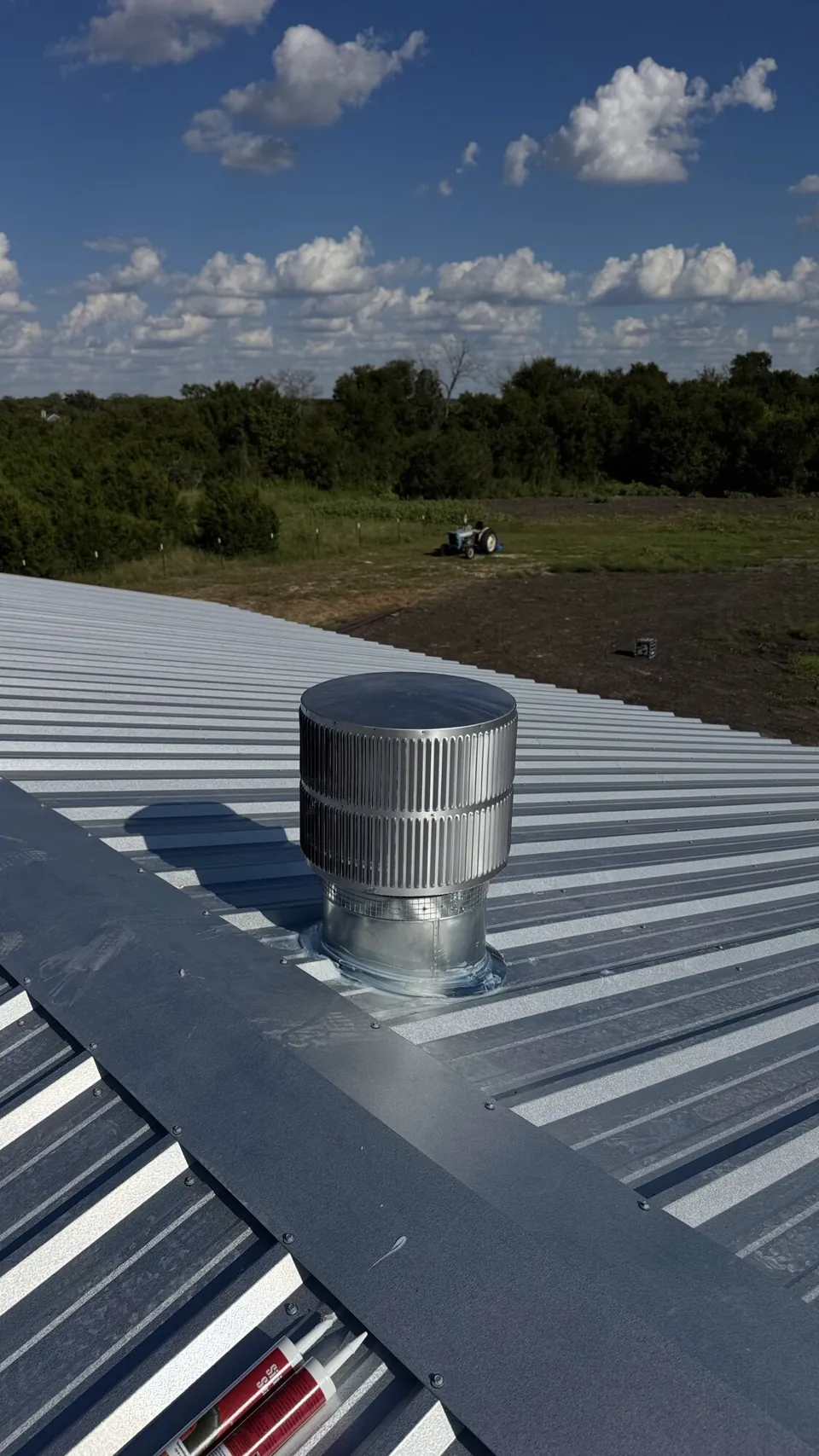 Chimney cap inspection — metal termination above a roof