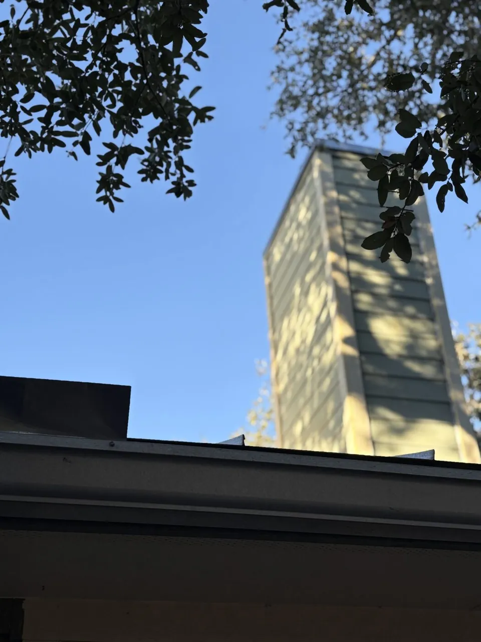 Chimney inspection — exterior chimney above the roofline