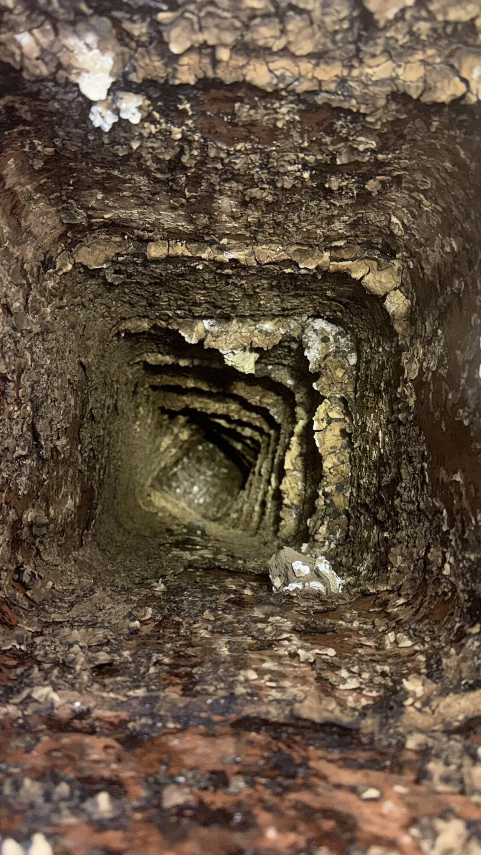 Chimney inspection — heavy deposits inside a stone flue